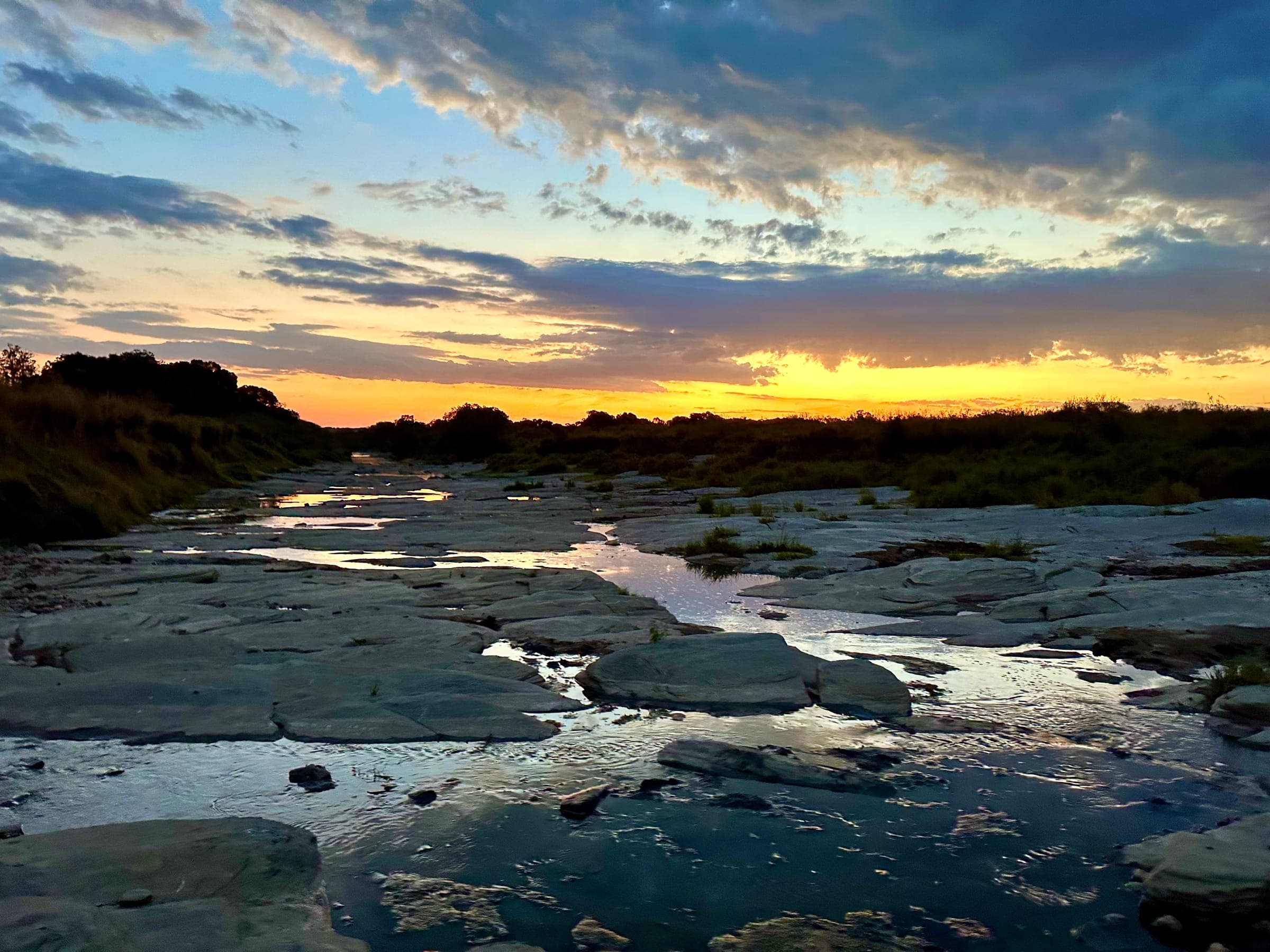 Sunset over a rocky river bed in Kenya